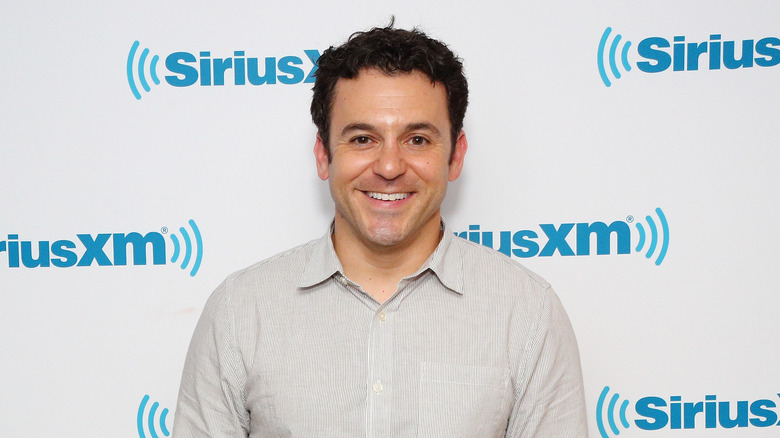 Fred Savage smiling on red carpet