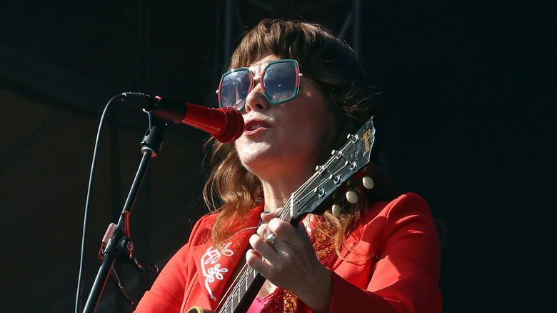 Jenny Lewis performing in oversized shades