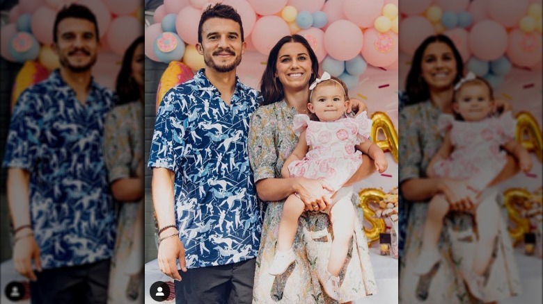 Alex Morgan holds her daughter, next to husband Servando Carrasco