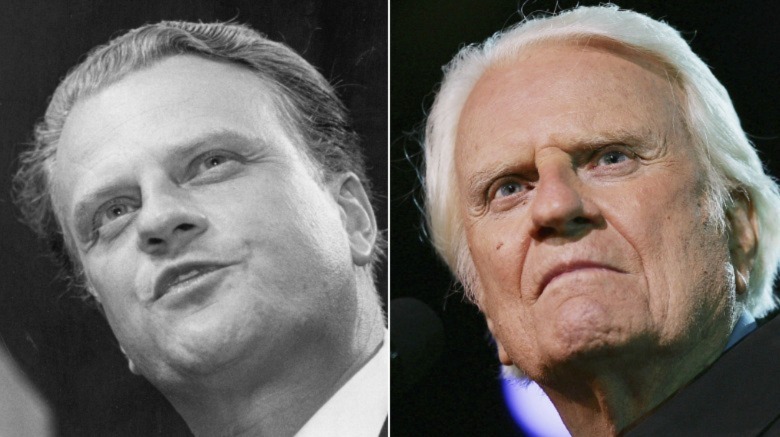 Billy Graham looking out at a crowd in front of a microphone 