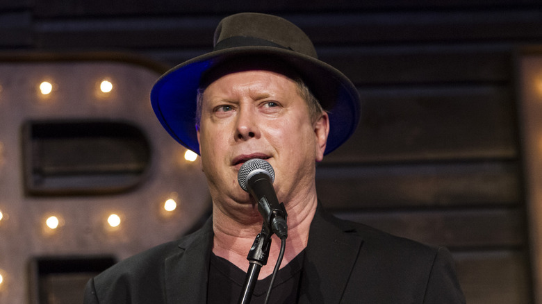 Darrell Hammond talking into a mic