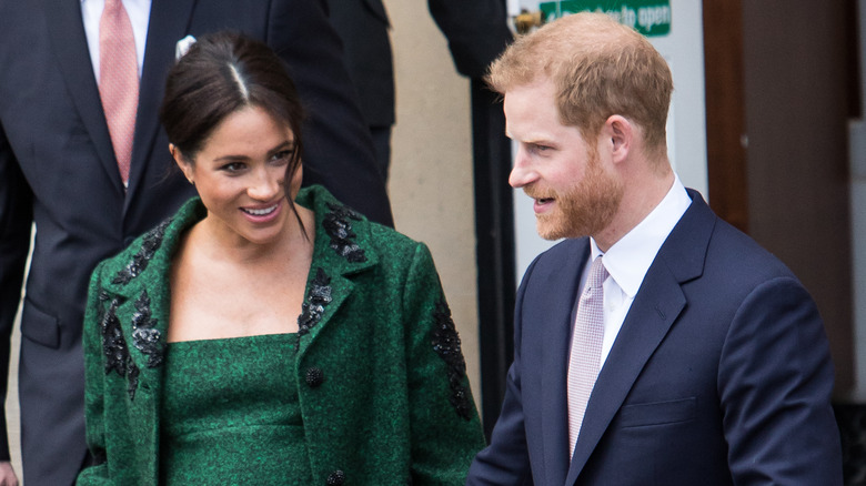 Meghan and Harry smiling at event in 2019