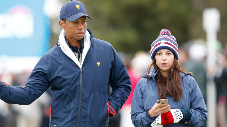 Erica Herman and Tiger Woods walking