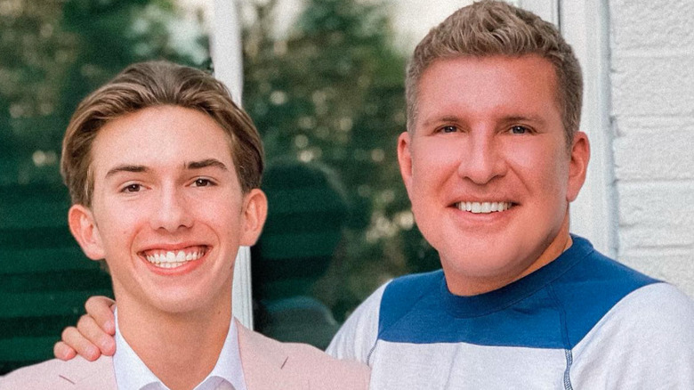 Todd and Grayson Chrisley pose 