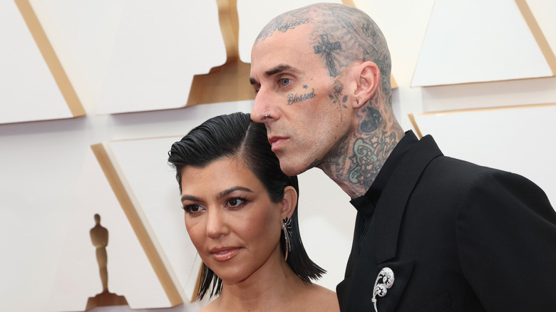 Kourtney Kardashian posing with Travis Barker