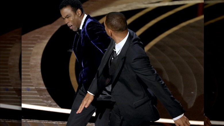 Chris Rock appearing to get slapped by Will Smith at 94th Oscars