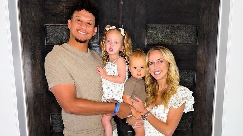 Patrick and Brittany Mahomes holding children