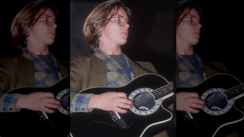 River Phoenix playing guitar