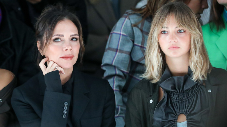 Mia Regan sits with Victoria Beckham