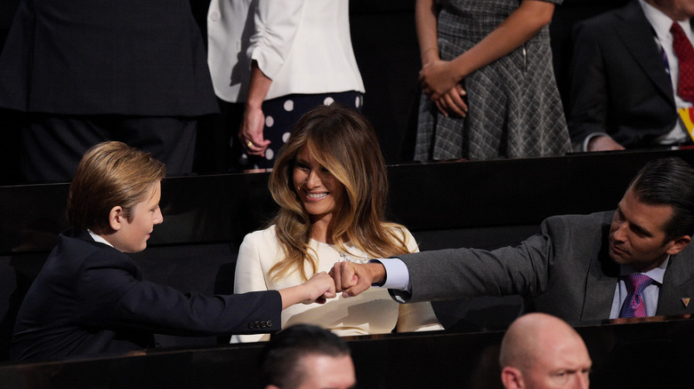 Barron Trump and Donald Jr. fist-bumping