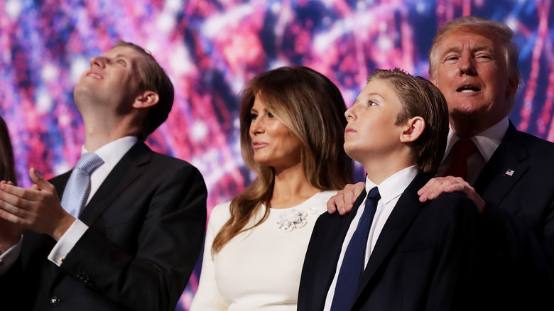 Eric Melania Barron Donald Trump posing on stage