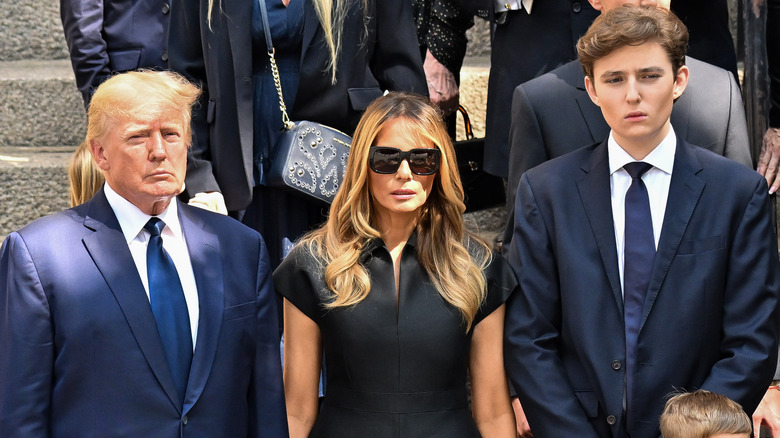 Donald, Melania, and Barron Trump at a funeral