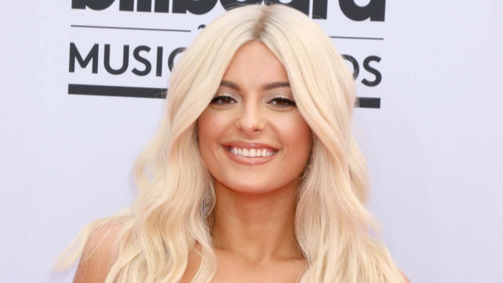 Bebe Rexha smiling on the American Music Awards red carpet