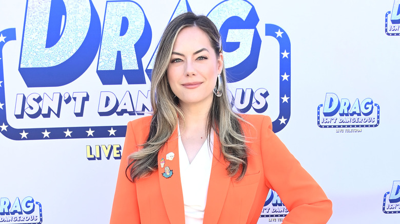 Annika Noelle wearing an orange blazer