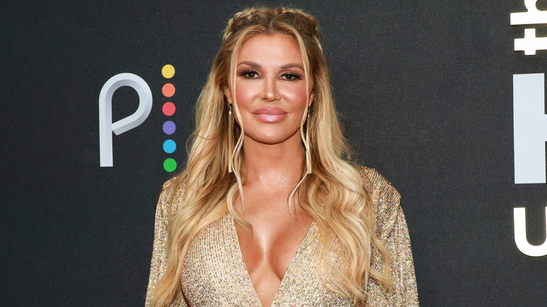 Brandi Glanville wearing gold dress