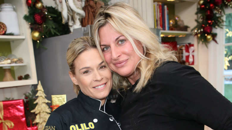 Cat Cora posing with wife Nicole Ehrlich