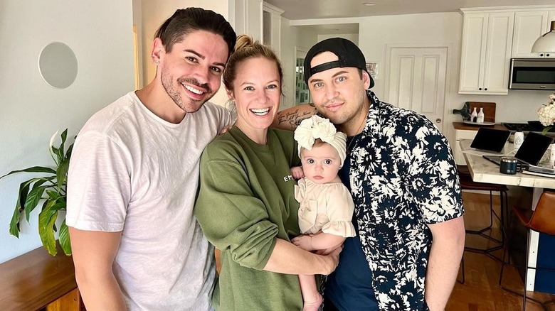 Danielle Savre holding Aspen Grey, posing between Chris and Jake Ogden-Harkins