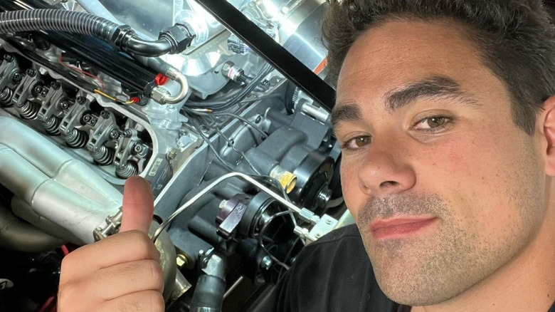 Griffin Steinfeld poses for a selfie by his car and gives a thumbs-up