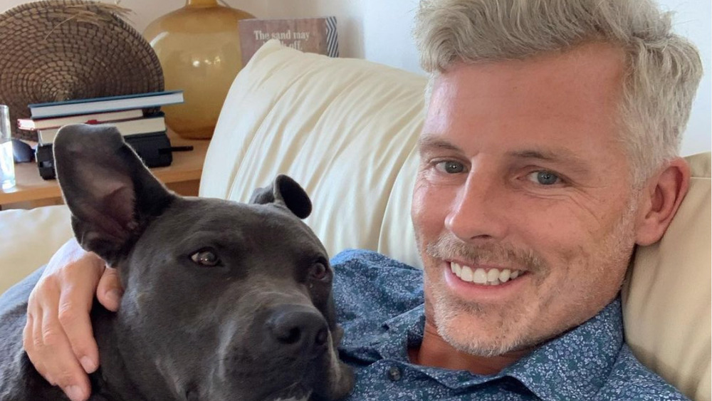 Des Bishop takes a selfie with his foster dog