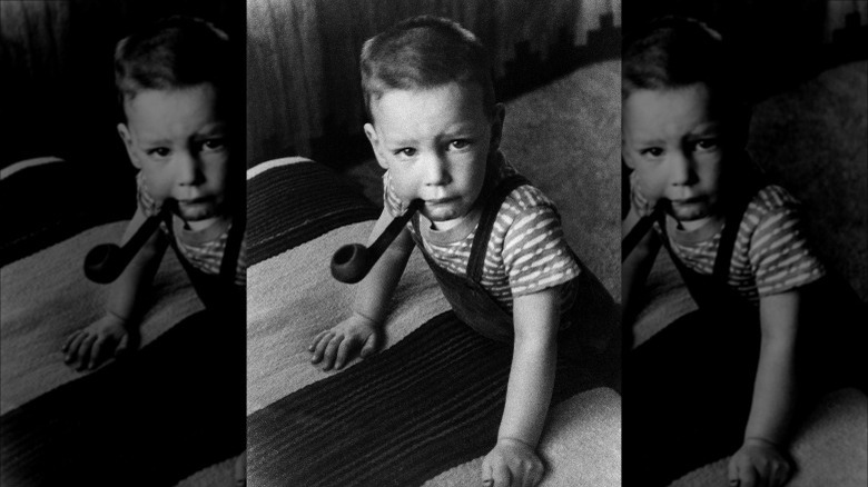 Young Peter Oppenheimer with pipe