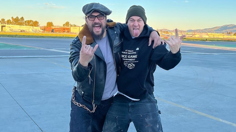 Jason Momoa and Channing Tatum posing together with rock hand-horns