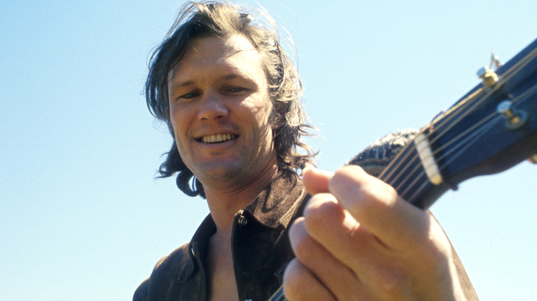 Kris Kristofferson poses with guitar