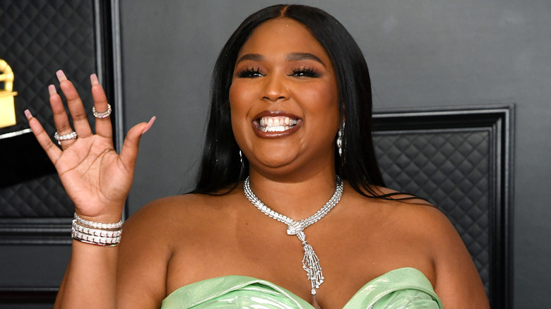 Lizzo smiling on the Grammy Awards red carpet