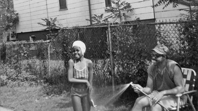 A young Michelle Obama with her dad