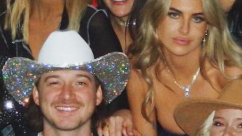 Morgan Wallen and Paige Lorenze posing for group photo