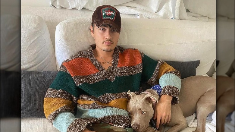 Brandon Thomas Lee on couch with dog