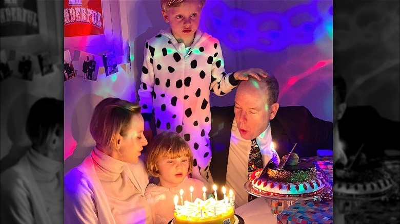 Princess Charlene, Gabriella, Jacques, Prince Albert blowing candles