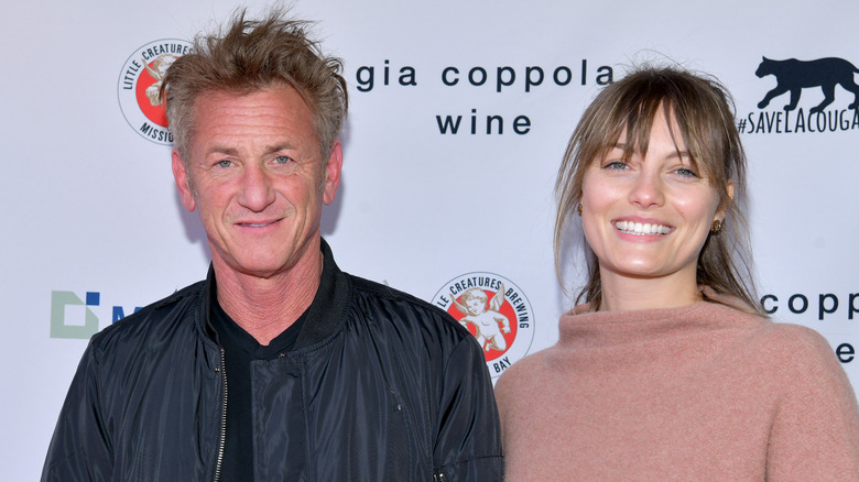 Sean Penn and Leila George smiling on the red carpet