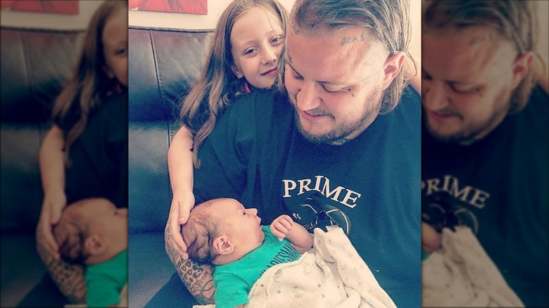 Jelly Roll smiling with his son and daughter