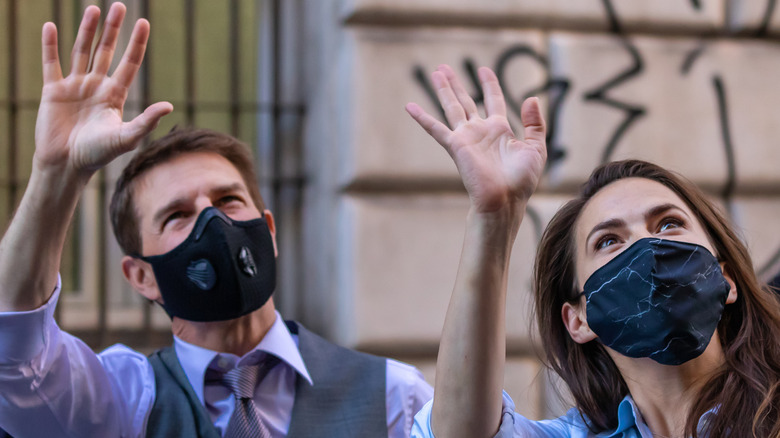 Tom Cruise and Hayley Atwell waving to fans