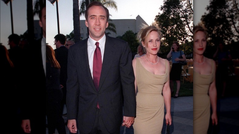 Nicolas Cage and Patricia Arquette hold hands on a red carpet