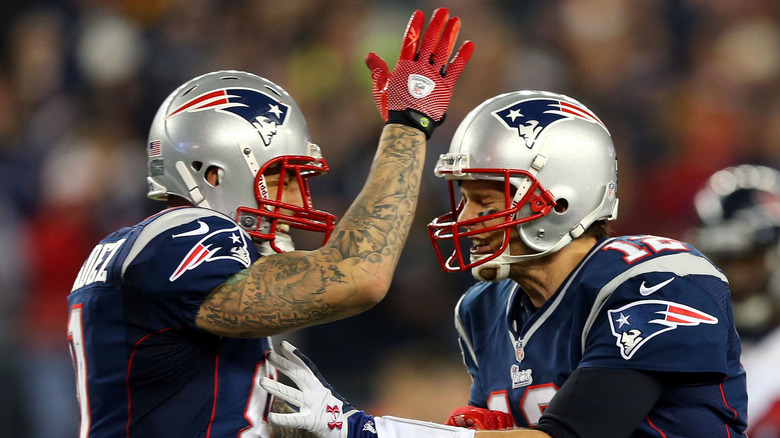 Aaron Hernandez and Tom Brady in uniform