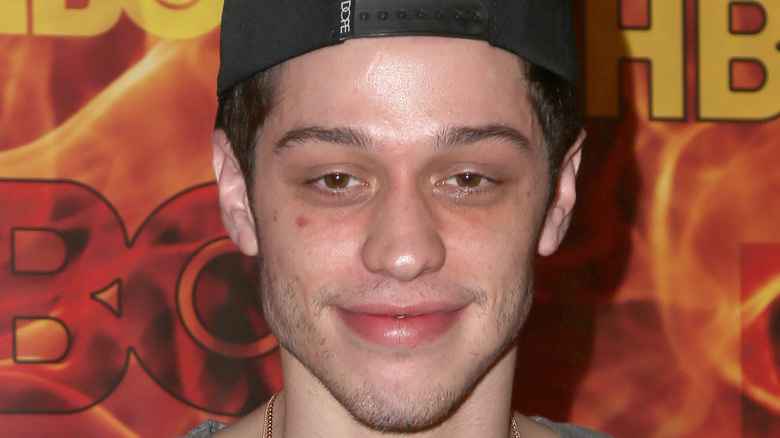 Pete Davidson on red carpet, smiling