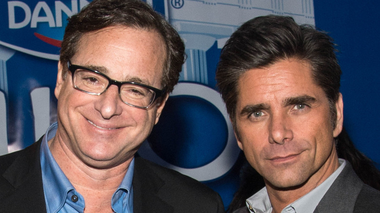 Bob Saget smiling, John Stamos, looking at camera