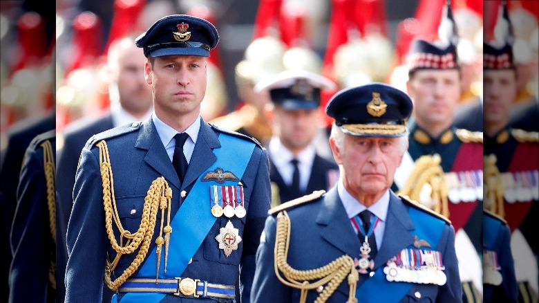 Prince William and King Charles walk behind the queen's coffin