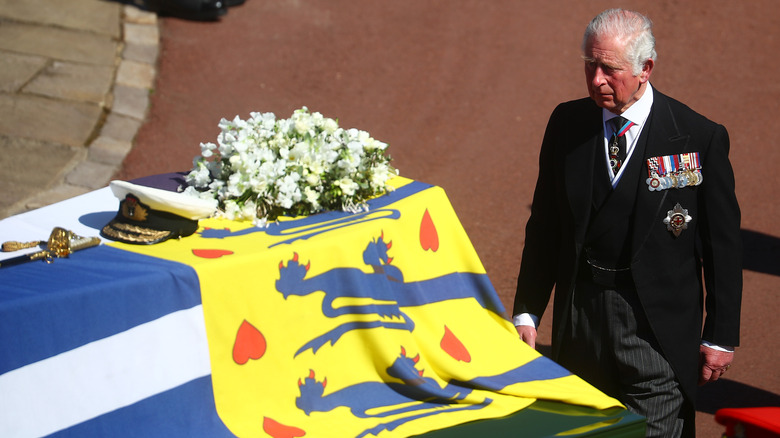 King Charles walking behind his father's coffin