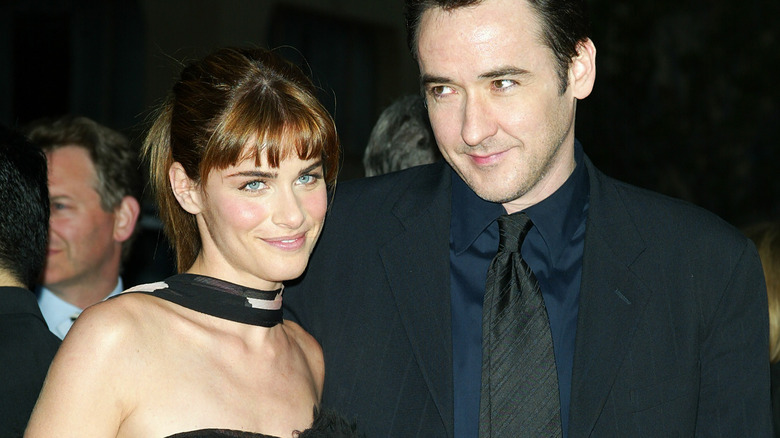 Amanda Peet, John Cusack posing