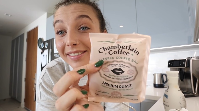 Screenshot of Emma Chamberlain holding her coffee