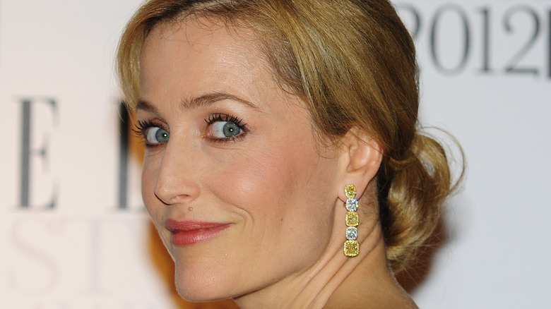 Gillian Anderson in profile while wearing long earrings