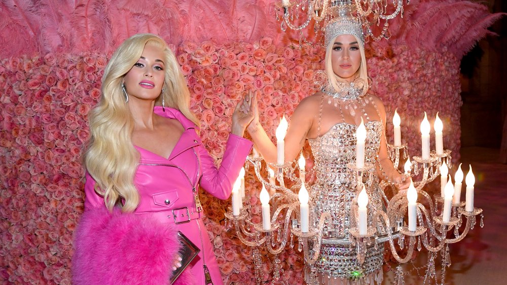 Kacey Musgraves and Katy Perry in front of pink rose wall