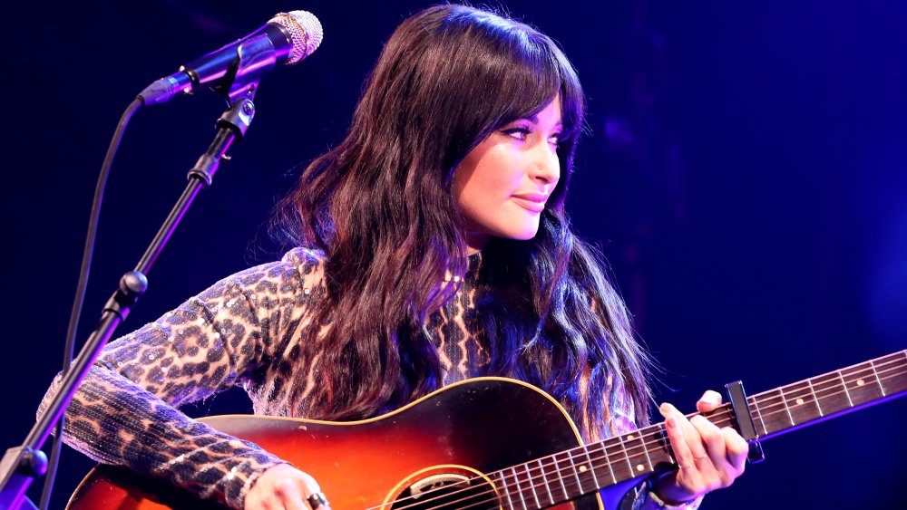 Kacey Musgraves on stage with guitar