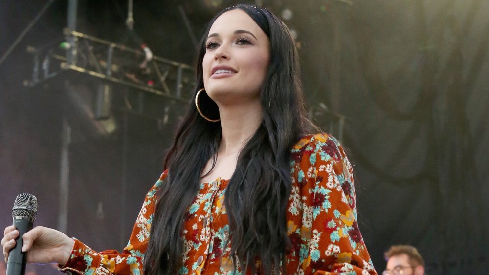 Kacey Musgraves in a floral dress on stage