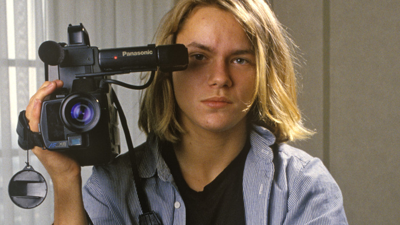 River Phoenix holding a video camera