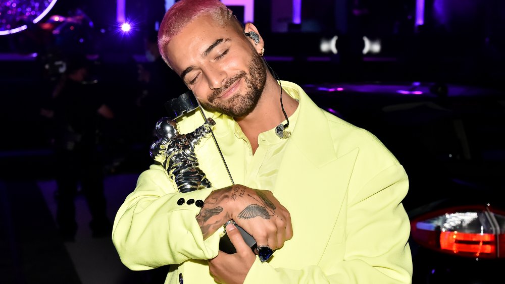 Maluma holding an MTV moonman