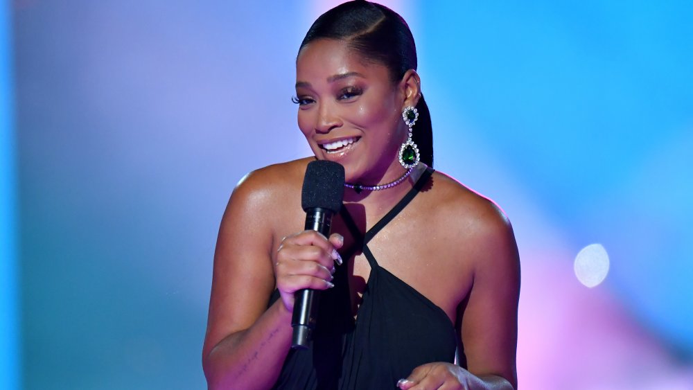 Keke Palmer on stage with microphone