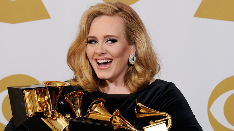 Adele holding Grammy awards